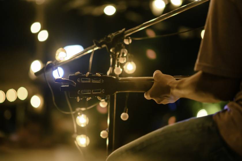 person on stage playing guitar