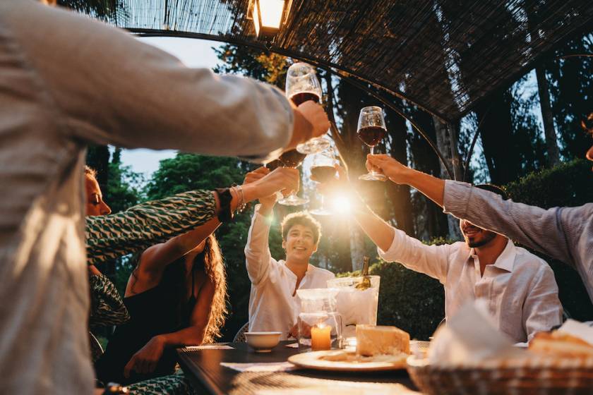 friends out at dinner raising glasses of wine in a toast